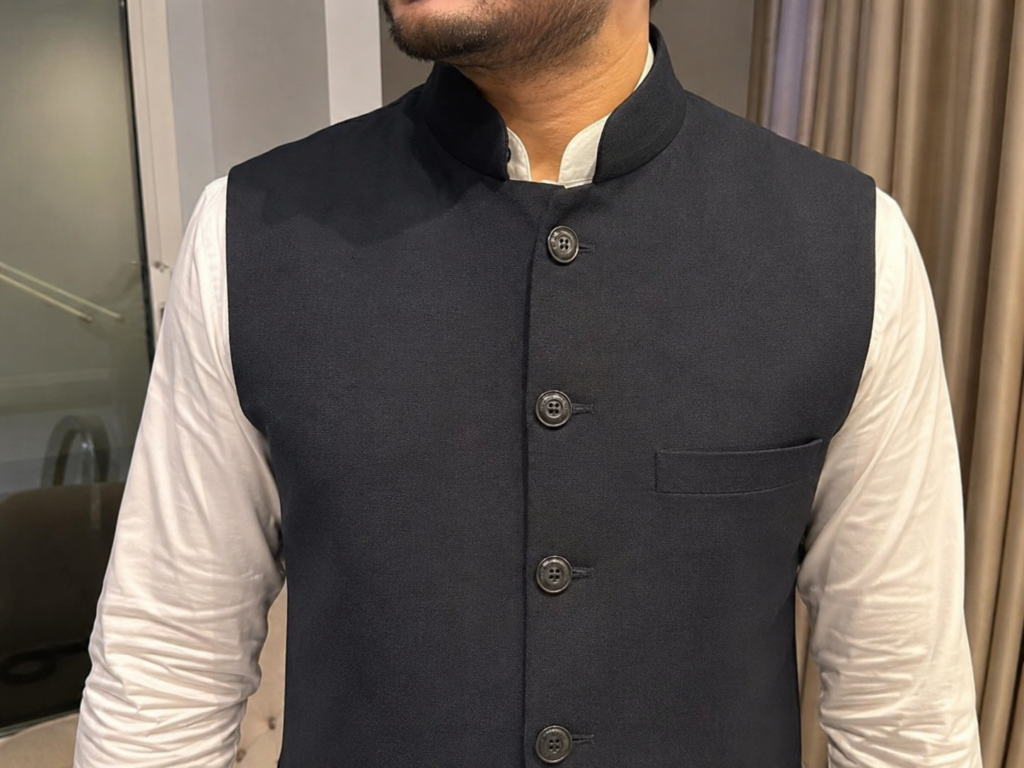 A tailored Nehru jacket layered neatly over a traditional Indian men's ethnic kurta