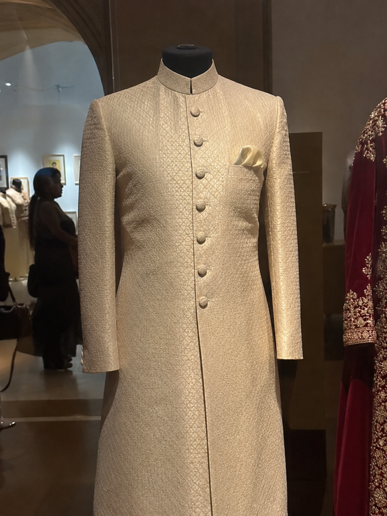 An elegant ivory silk Bollywood style sherwani for men displayed on a mannequin