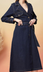 Full-length product view of a dark blue longline denim coat against a white background, styled with classic trench details including double-breasted buttons, lapels, long sleeves, and a tied denim belt at the waist.